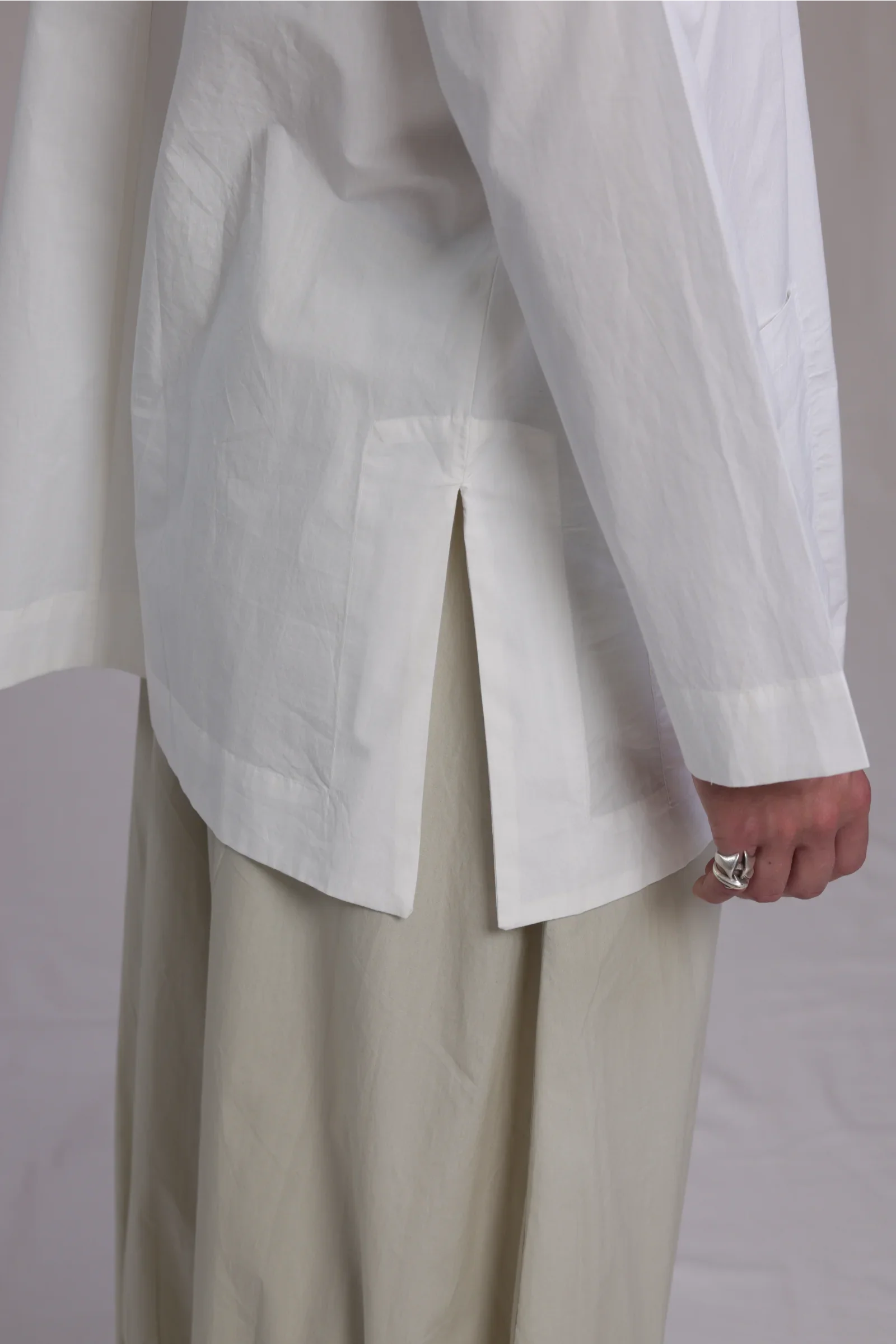 ALBI Sei Shirt, a long oversized cotton poplin band collar shirt with low patch pockets