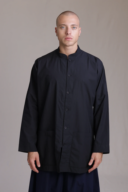 ALBI Sei Shirt, a long oversized cotton poplin band collar shirt with low patch pockets