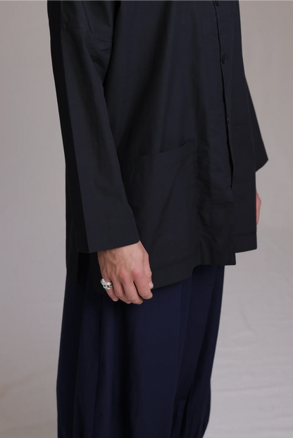 ALBI Sei Shirt, a long oversized cotton poplin band collar shirt with low patch pockets