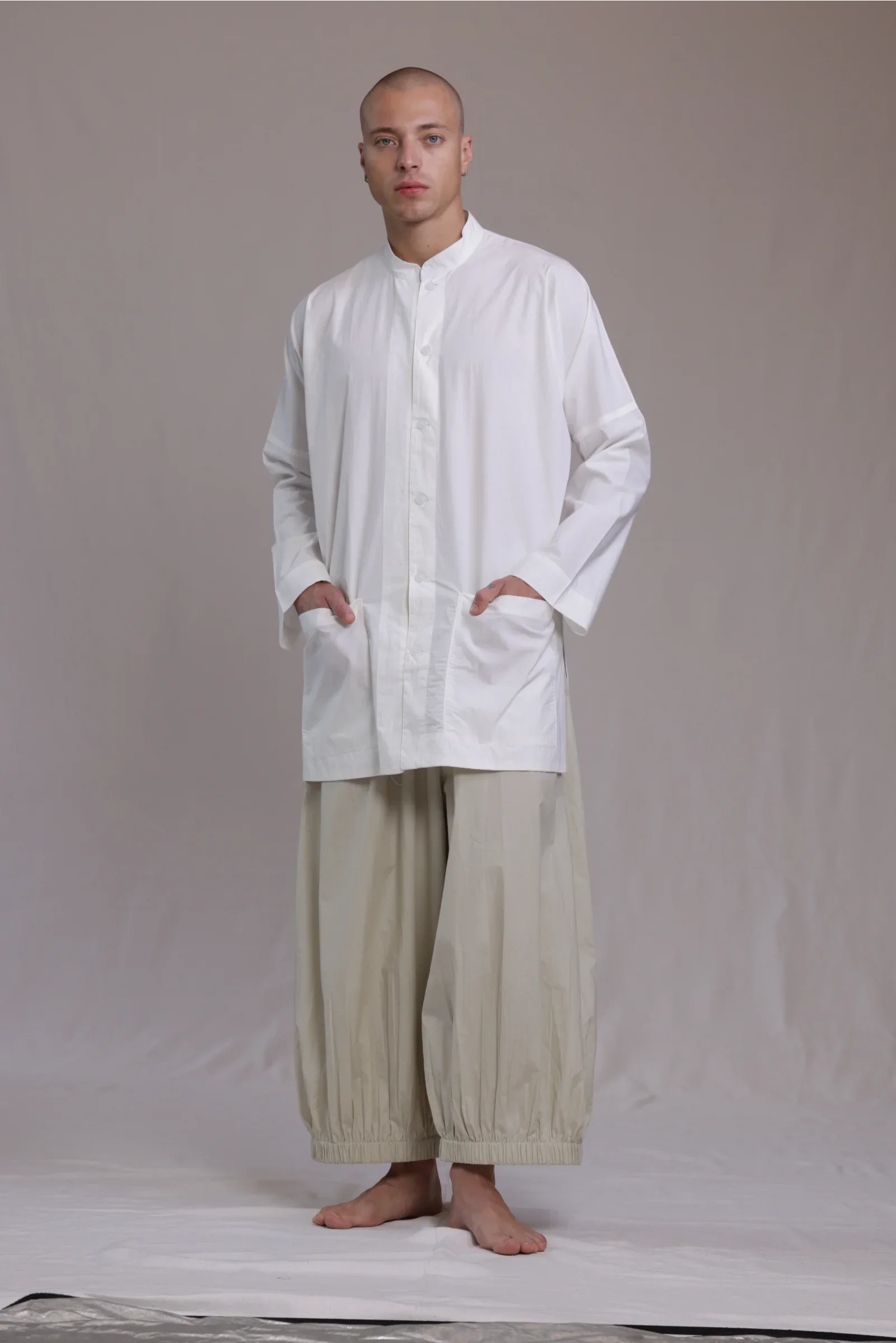 ALBI Sei Shirt, a long oversized cotton poplin band collar shirt with low patch pockets