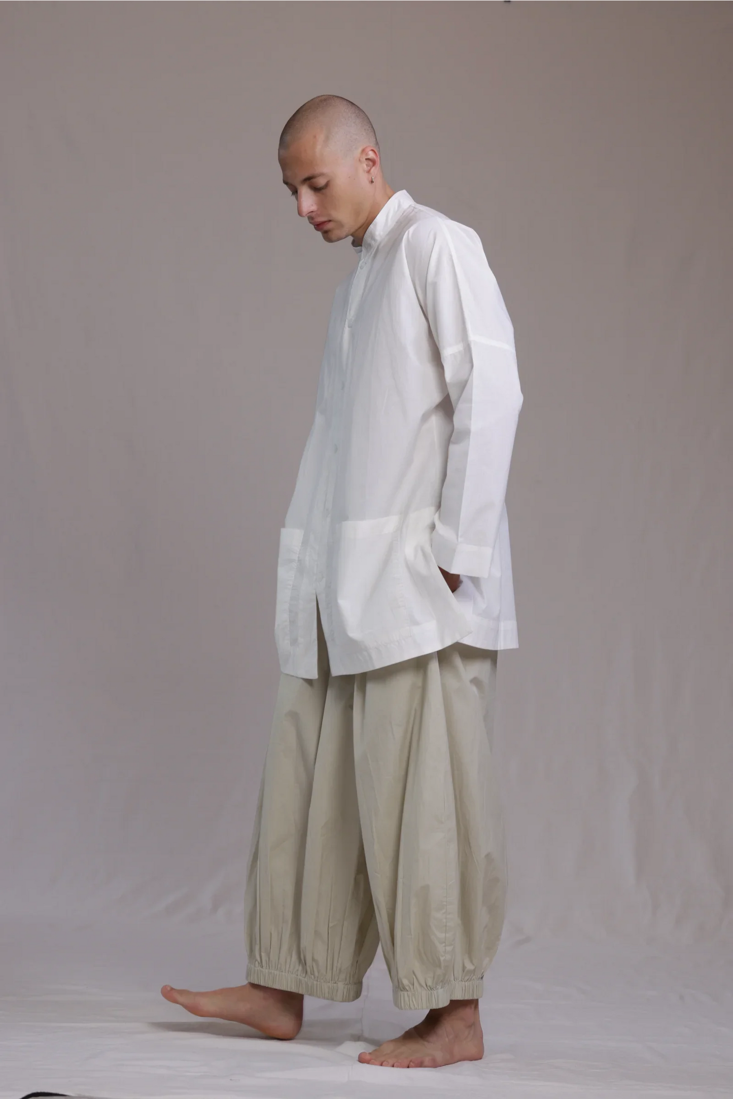 ALBI Sei Shirt, a long oversized cotton poplin band collar shirt with low patch pockets